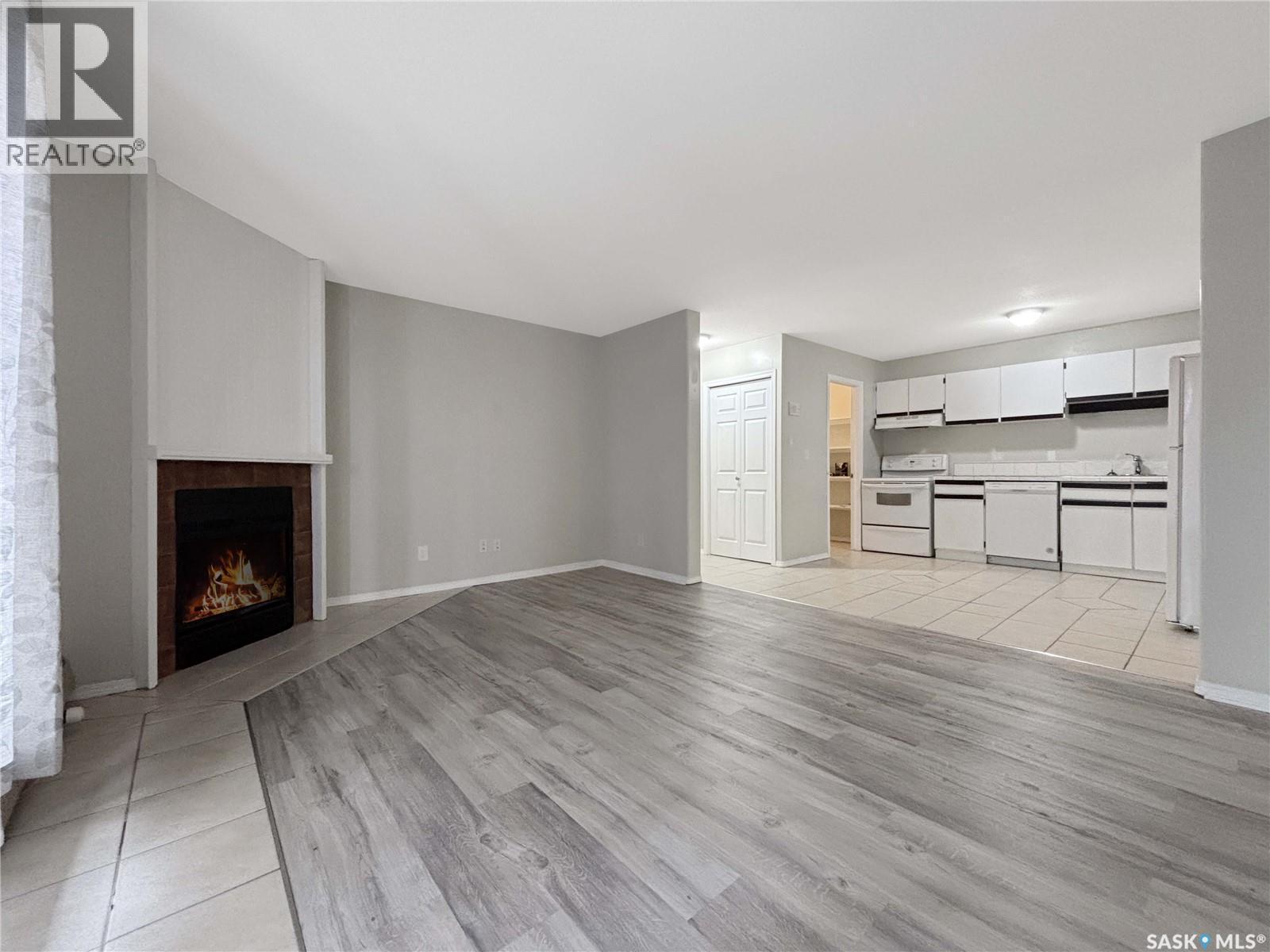 B03 245 Kingsmere Boulevard, Saskatoon, SK - Indoor Photo Showing Living Room With Fireplace