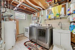 Laundry room with summer kitchen (fridge & stove). -