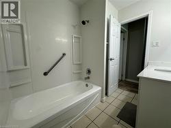 Full bathroom with vanity, shower / washtub combination, and light tile patterned floors -