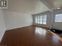 Foyer entrance featuring a textured ceiling and dark wood finished floors -