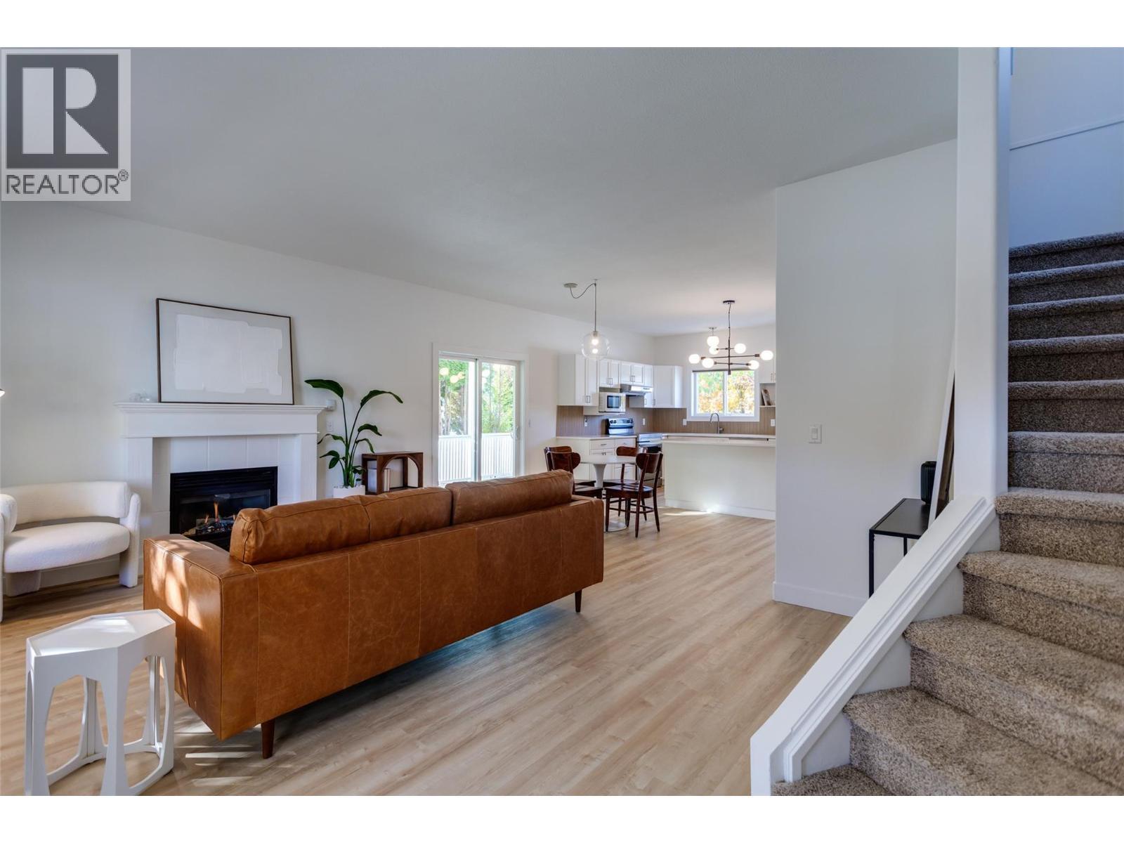 Main home living room - 388 Mccarren Avenue, Kelowna, BC - Indoor Photo Showing Living Room With Fireplace