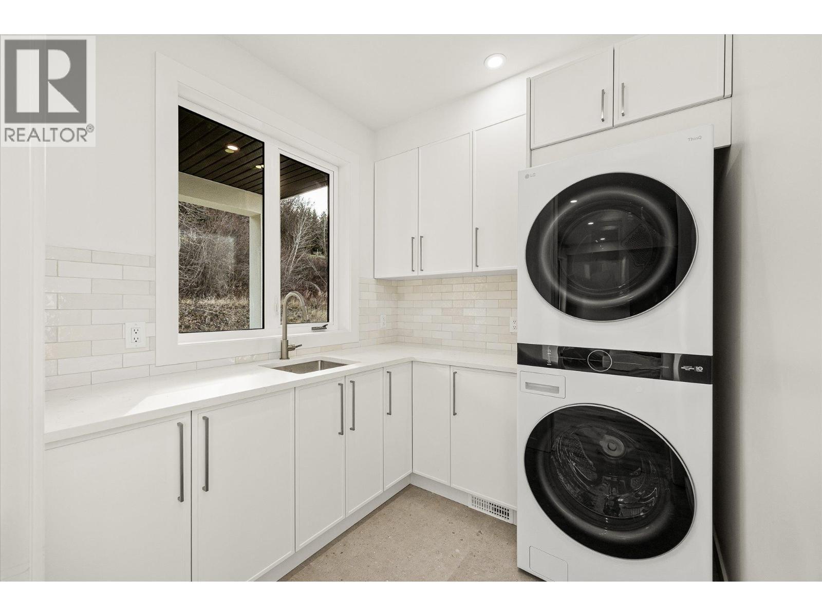 conveniently off the kitchen - 980 Bull Crescent, Kelowna, BC - Indoor Photo Showing Laundry Room