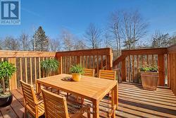 deck overlooks forest with creek -