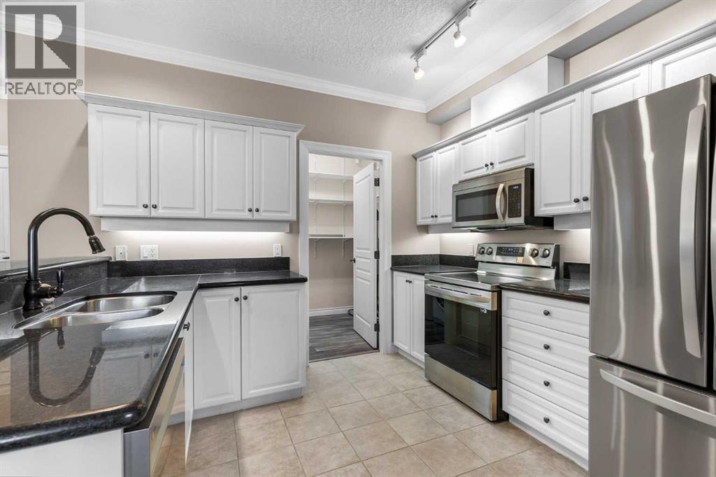 205, 59 22 Avenue Sw, Calgary, AB - Indoor Photo Showing Kitchen With Double Sink