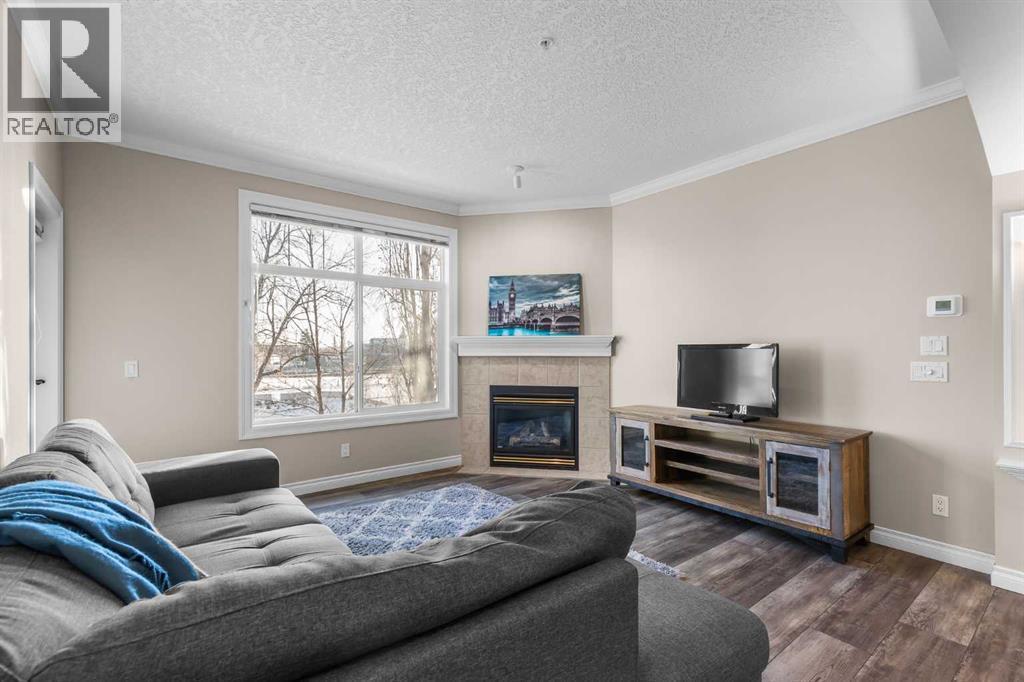 205, 59 22 Avenue Sw, Calgary, AB - Indoor Photo Showing Living Room With Fireplace