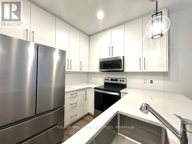 233 - 175 Doan Drive, Middlesex Centre, ON - Indoor Photo Showing Kitchen With Stainless Steel Kitchen