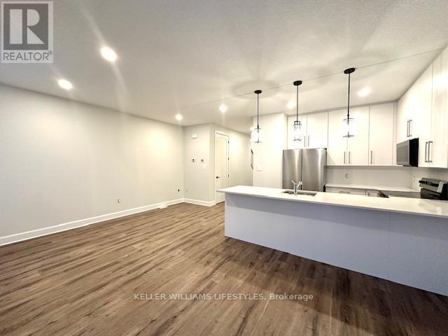 233 - 175 Doan Drive, Middlesex Centre, ON - Indoor Photo Showing Kitchen With Double Sink