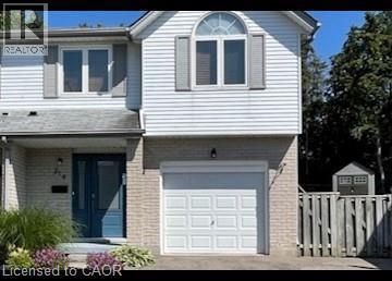 Traditional home with brick siding, a garage, and driveway - 214 Benesfort Crescent, Kitchener, ON - Outdoor With Exterior