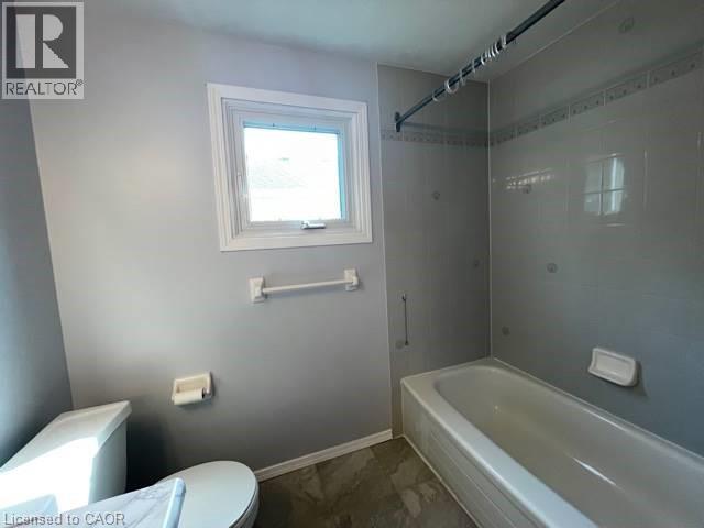 Bathroom featuring shower / washtub combination and dark marble finish floors - 214 Benesfort Crescent, Kitchener, ON - Indoor Photo Showing Bathroom