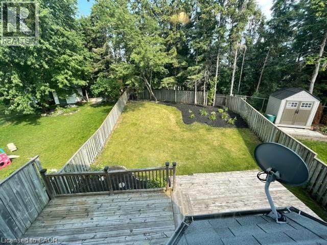 Fenced backyard featuring a storage unit and a deck - 214 Benesfort Crescent, Kitchener, ON - Outdoor With Deck Patio Veranda