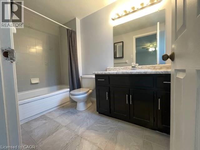 Full bathroom featuring shower / bath combination with curtain, vanity, and ceiling fan - 214 Benesfort Crescent, Kitchener, ON - Indoor Photo Showing Bathroom