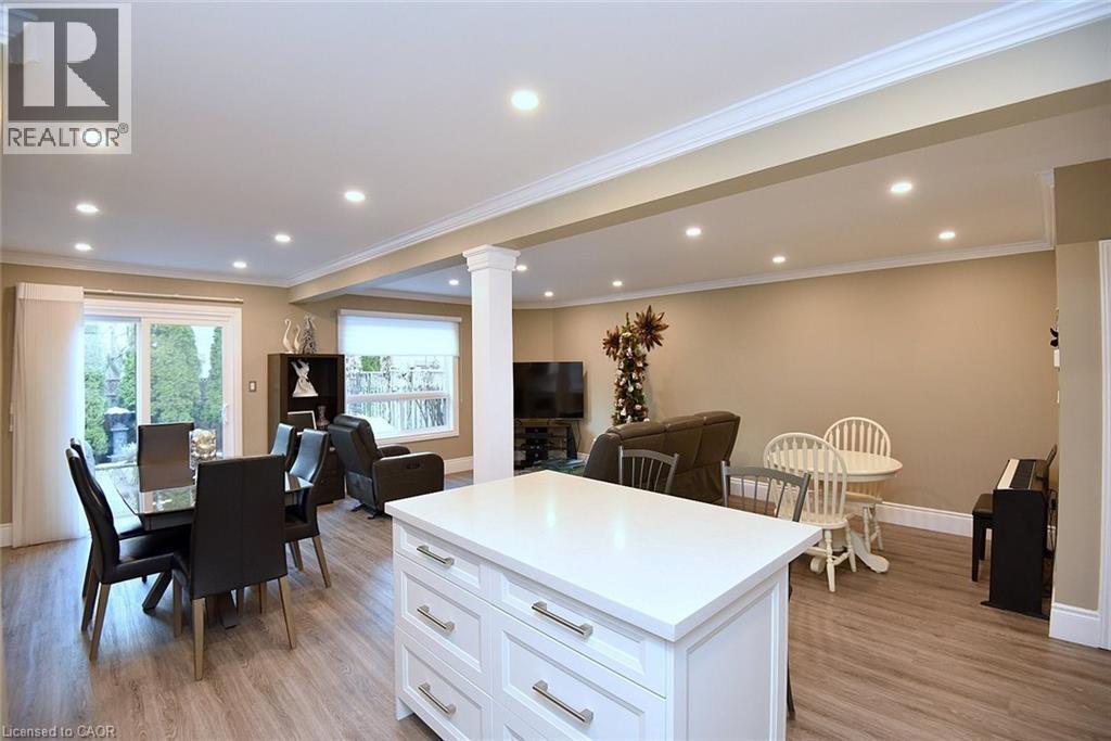 Kitchen with white cabinets, light wood finished floors, open floor plan, ornamental molding, and recessed lighting - 1245 Stephenson Drive Unit# 20, Burlington, ON
