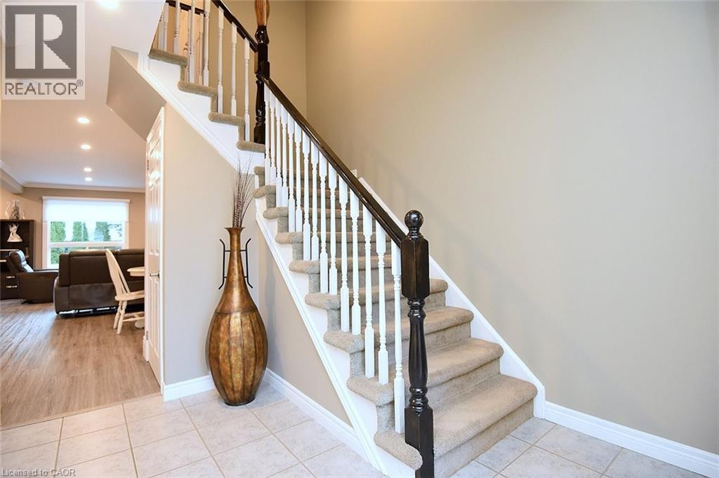 Stairs with tile patterned flooring, recessed lighting, and crown molding - 1245 Stephenson Drive Unit# 20, Burlington, ON