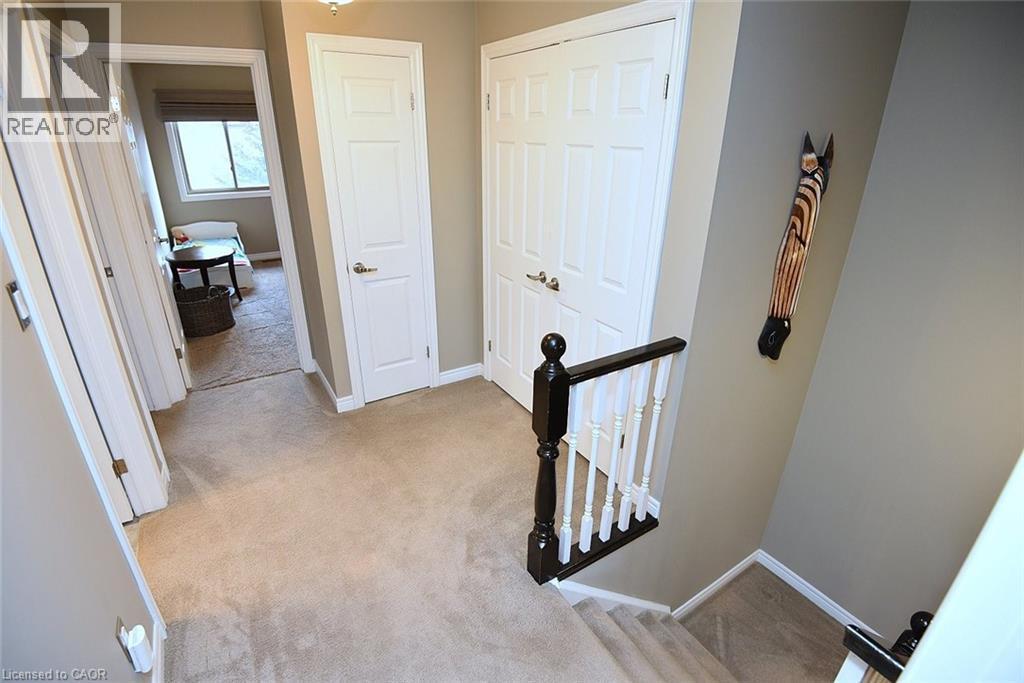 Corridor with light colored carpet and an upstairs landing - 1245 Stephenson Drive Unit# 20, Burlington, ON