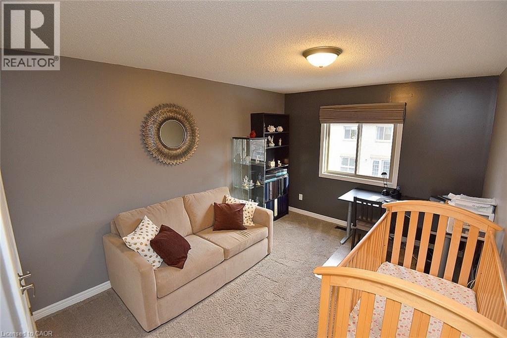 Bedroom featuring a textured ceiling and light colored carpet - 1245 Stephenson Drive Unit# 20, Burlington, ON