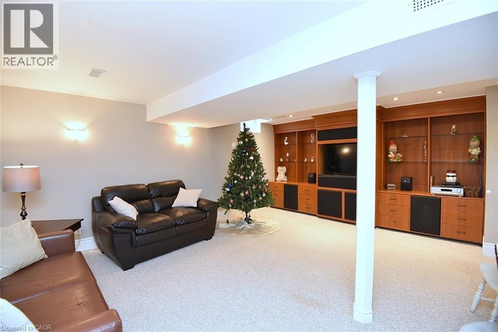 Living area with light colored carpet and built in features - 1245 Stephenson Drive Unit# 20, Burlington, ON