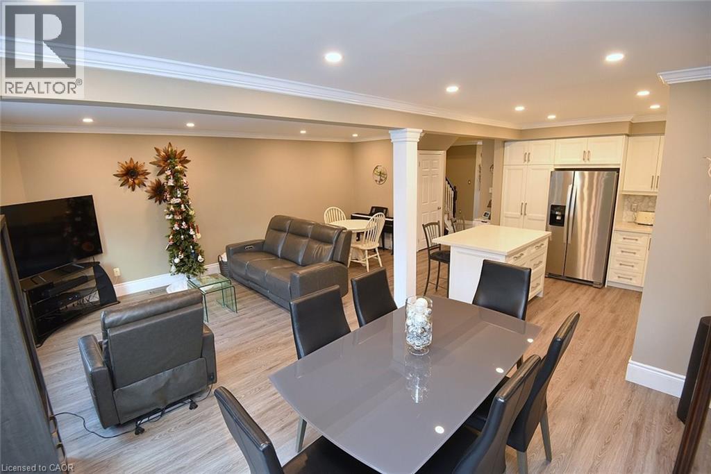 Dining space with ornate columns, light wood finished floors, recessed lighting, and crown molding - 1245 Stephenson Drive Unit# 20, Burlington, ON