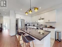 Kitchen, with Granite counters & centre island. -