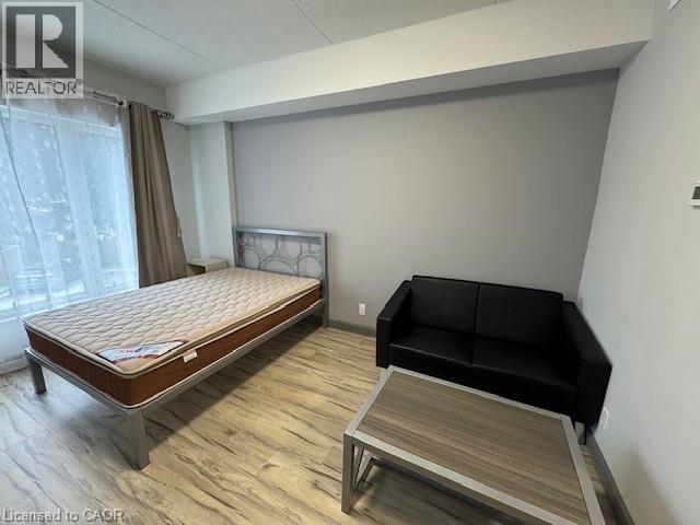 Bedroom with wood finished floors and baseboards - 77 Leland Street Unit# 223, Hamilton, ON - Indoor Photo Showing Bedroom