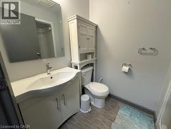 Full bathroom with a shower with curtain, vanity, and wood tiled floors -