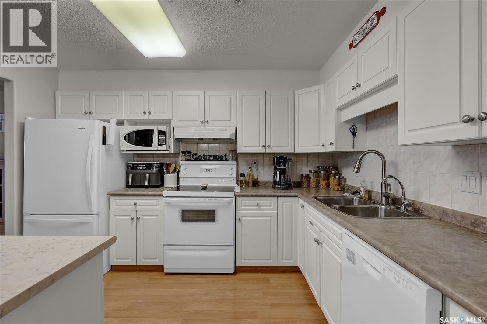 110 2300 Tell Place, Regina, SK - Indoor Photo Showing Kitchen With Double Sink