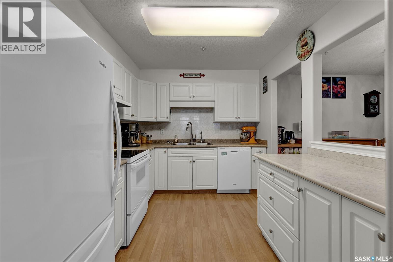 110 2300 Tell Place, Regina, SK - Indoor Photo Showing Kitchen With Double Sink