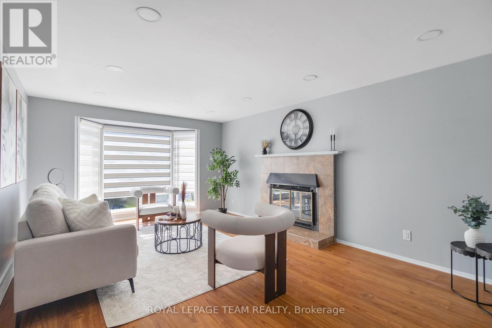 Photos may be staged to show design potential - 2 Brookhaven Court, Ottawa, ON - Indoor Photo Showing Living Room With Fireplace
