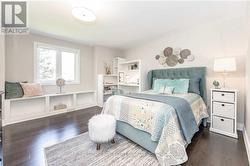 Thir Bedroom with Hardwood Flooring -