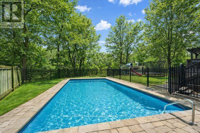 Heated Inground Pool with a Waterfall Feature - 1302 Hillview Crescent, Oakville, ON - Outdoor With In Ground Pool With Backyard