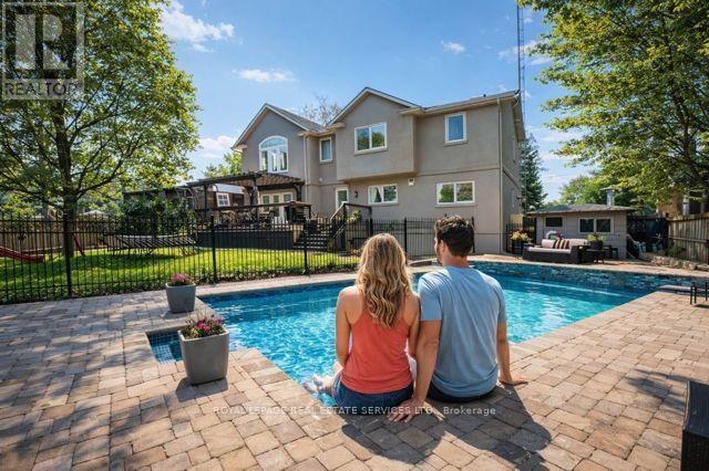Heated Inground Pool with a Waterfall Feature - 1302 Hillview Crescent, Oakville, ON - Outdoor With In Ground Pool With Deck Patio Veranda