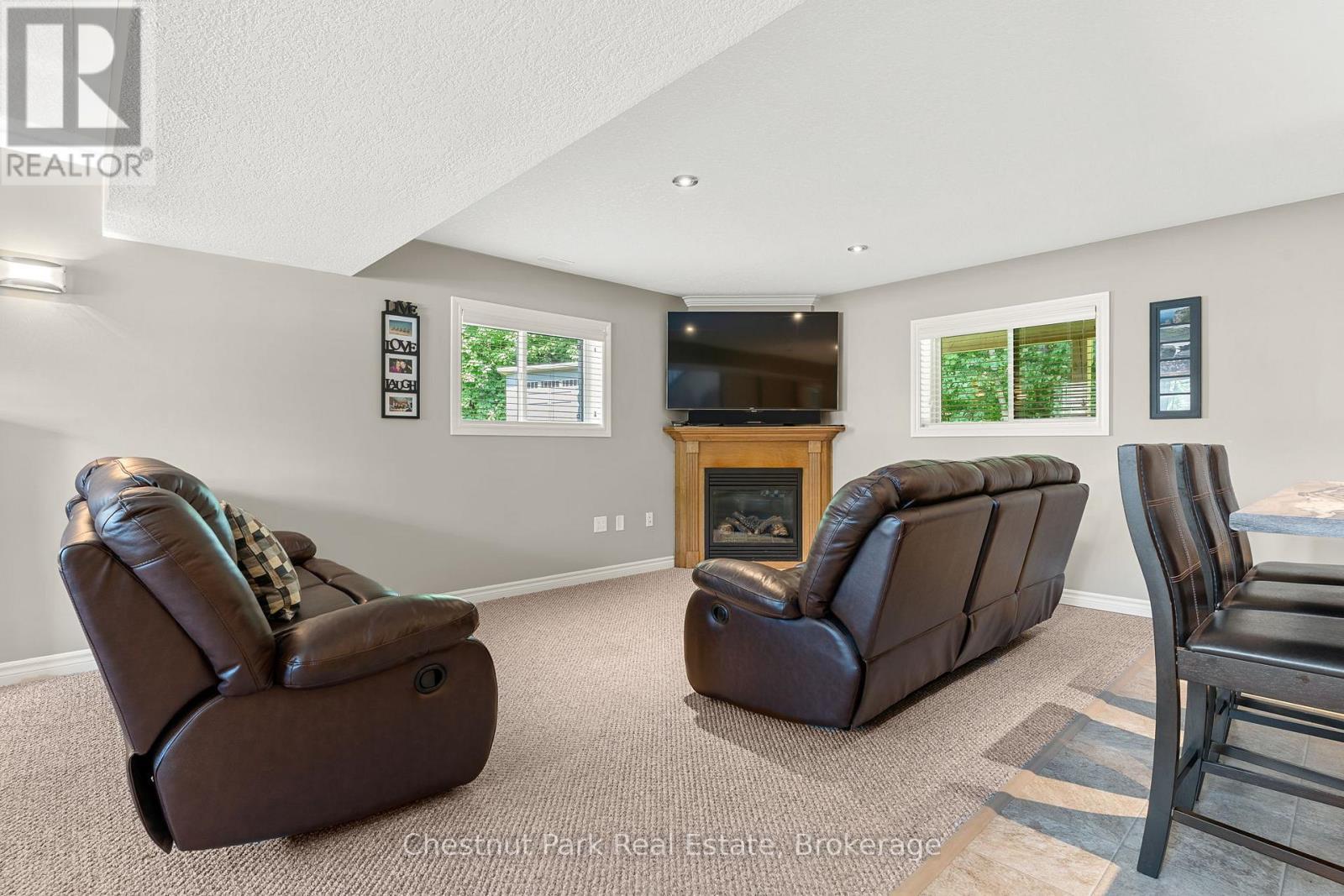 Cozy lower level gas fireplace - 207 2Nd Street W, Owen Sound, ON - Indoor Photo Showing Other Room With Fireplace