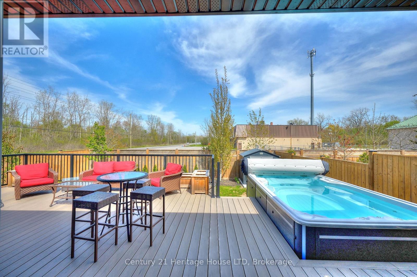 View of the deck & swim spa from the patio doors - 1050 Kettle Court, Fort Erie (Crescent Park), ON - Outdoor With Above Ground Pool With Deck Patio Veranda