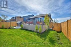 Backyard fenced in with swim spa and deck -