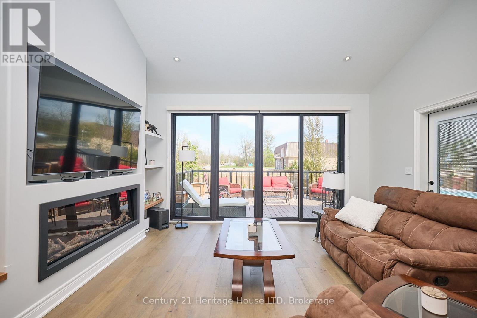 Living room w/ electric fireplace & w/o to deck - 1050 Kettle Court, Fort Erie (Crescent Park), ON - Indoor Photo Showing Living Room With Fireplace