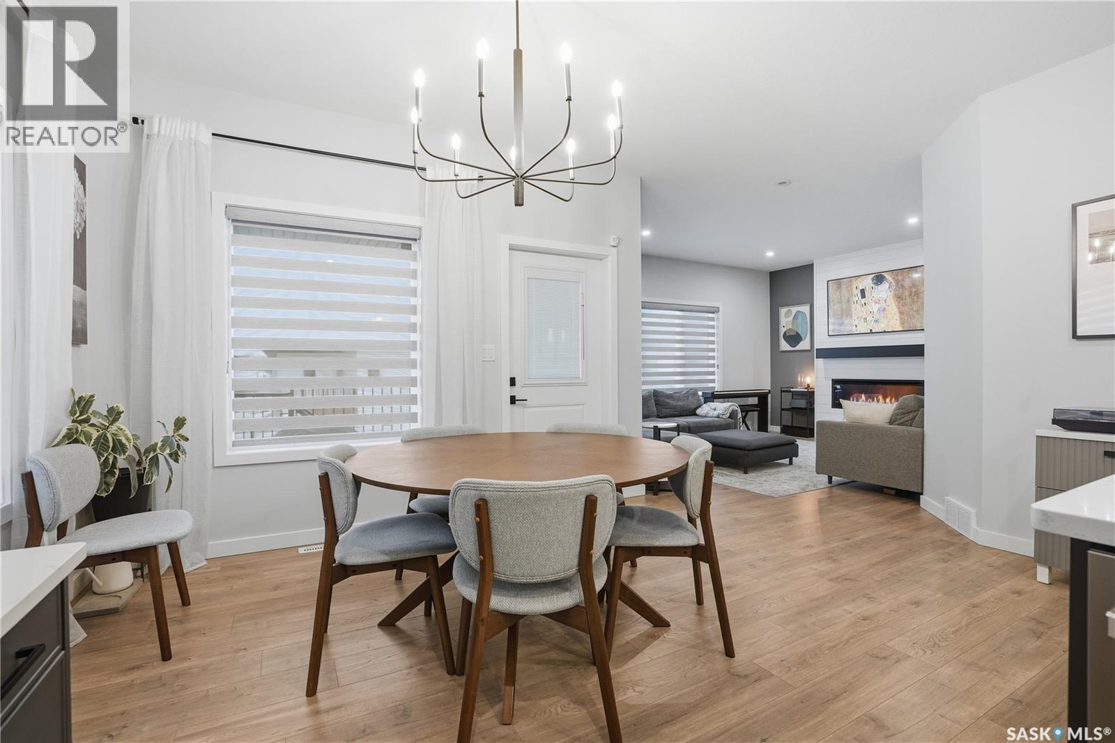 746 Bentley Manor, Saskatoon, SK - Indoor Photo Showing Dining Room With Fireplace