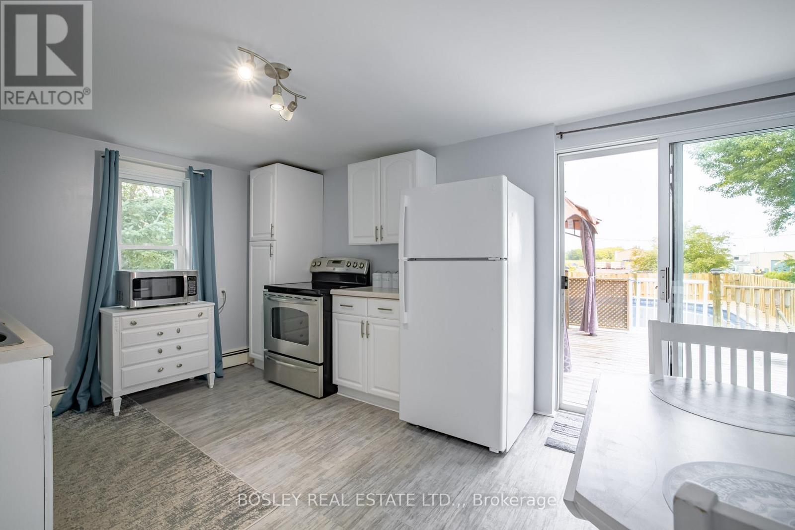 Patio doors out to deck, gazebo, pool - 1609 Eighth Avenue, St. Catharines (Rural Eighth), ON - Indoor Photo Showing Kitchen