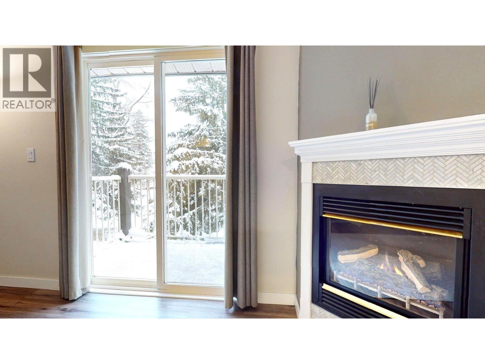 1802 Alpine Drive Unit# 302B, Elkford, BC - Indoor Photo Showing Living Room With Fireplace