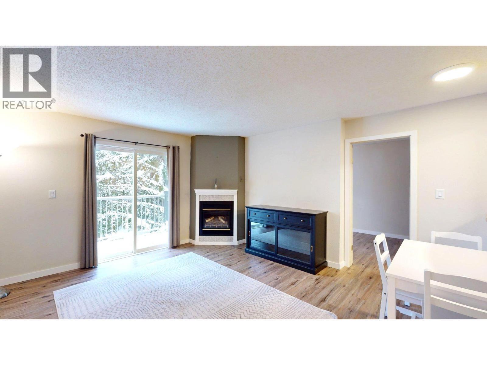 1802 Alpine Drive Unit# 302B, Elkford, BC - Indoor Photo Showing Living Room With Fireplace