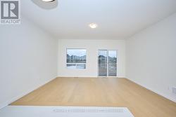 Great Room with hardwood floor & w/o to back deck -