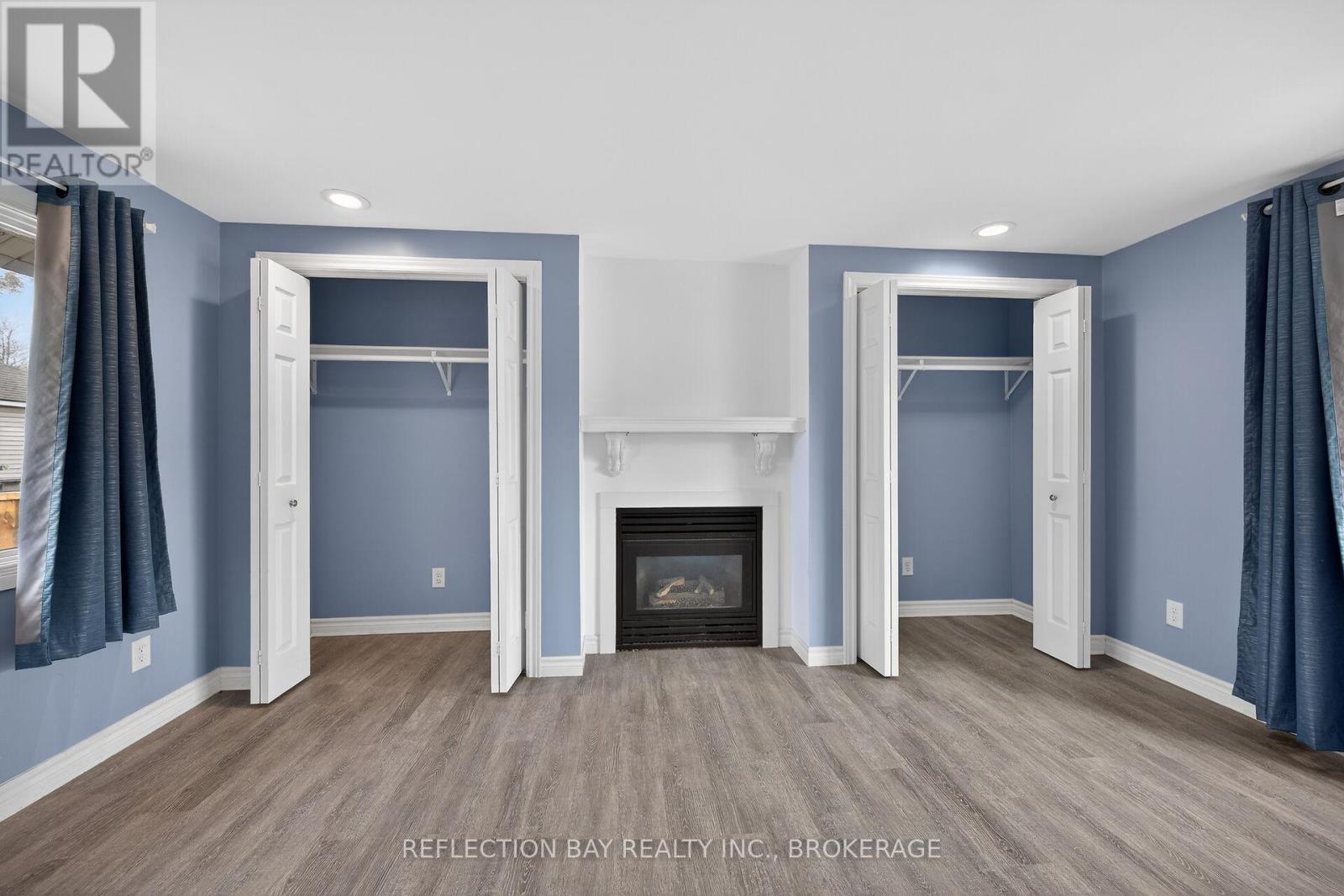 Double closets and gas fireplace in the Primary - 3794 Mathewson Avenue, Fort Erie (Crystal Beach), ON - Indoor With Fireplace