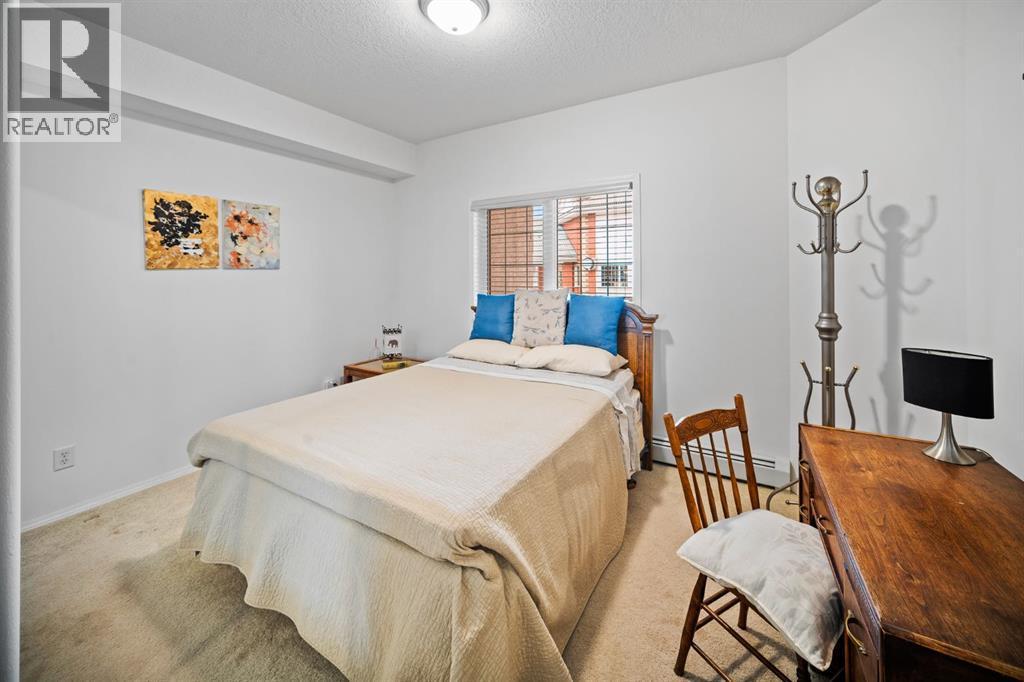 201, 223 Tuscany Springs Boulevard Nw, Calgary, AB - Indoor Photo Showing Bedroom