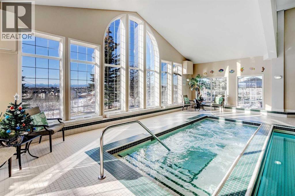 201, 223 Tuscany Springs Boulevard Nw, Calgary, AB - Indoor Photo Showing Other Room With In Ground Pool
