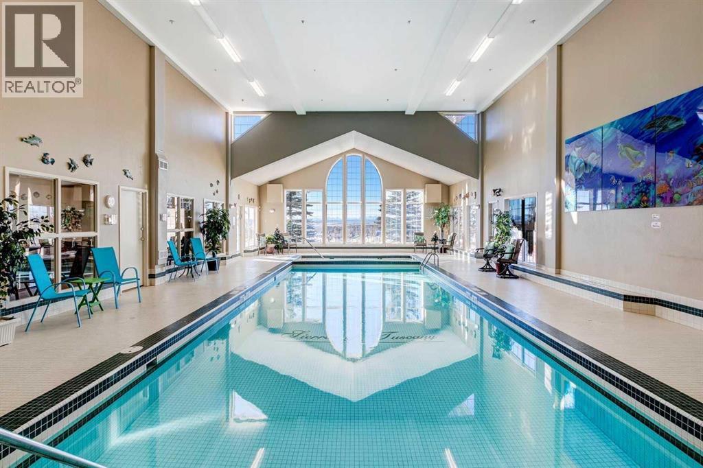 201, 223 Tuscany Springs Boulevard Nw, Calgary, AB - Indoor Photo Showing Other Room With In Ground Pool