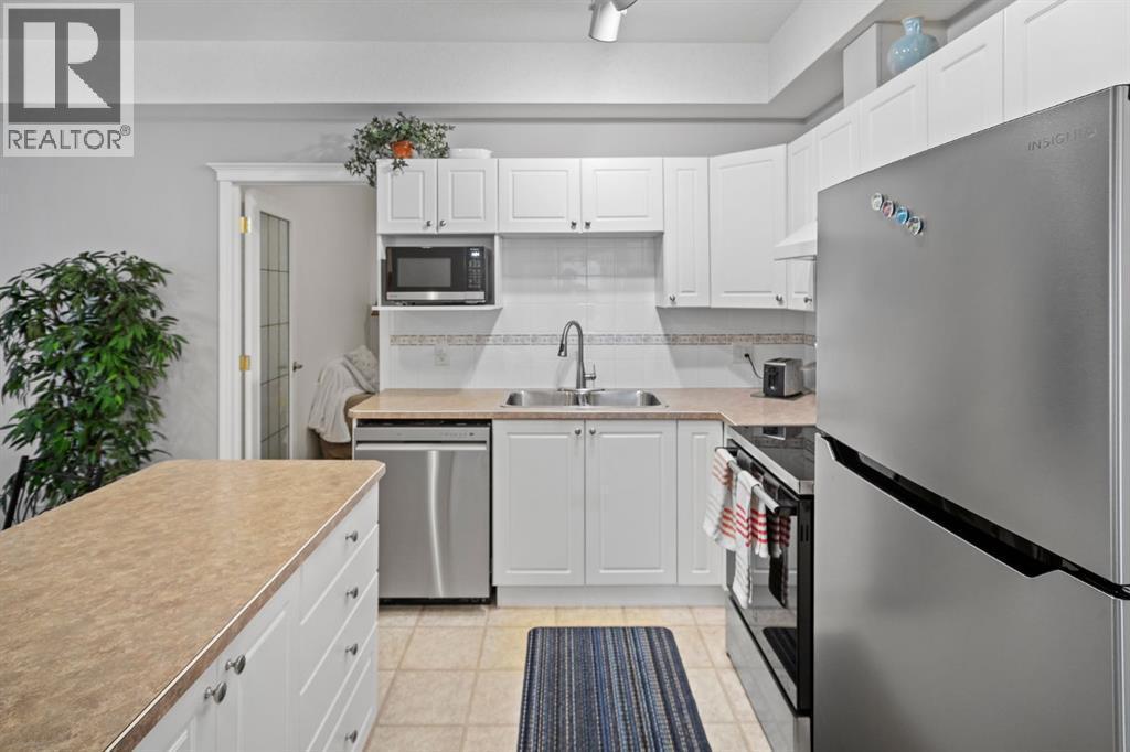 201, 223 Tuscany Springs Boulevard Nw, Calgary, AB - Indoor Photo Showing Kitchen With Stainless Steel Kitchen With Double Sink