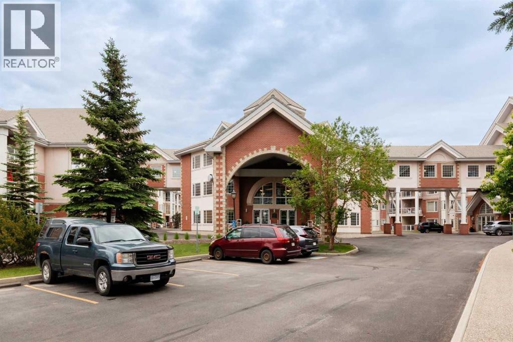 201, 223 Tuscany Springs Boulevard Nw, Calgary, AB - Outdoor With Balcony With Facade