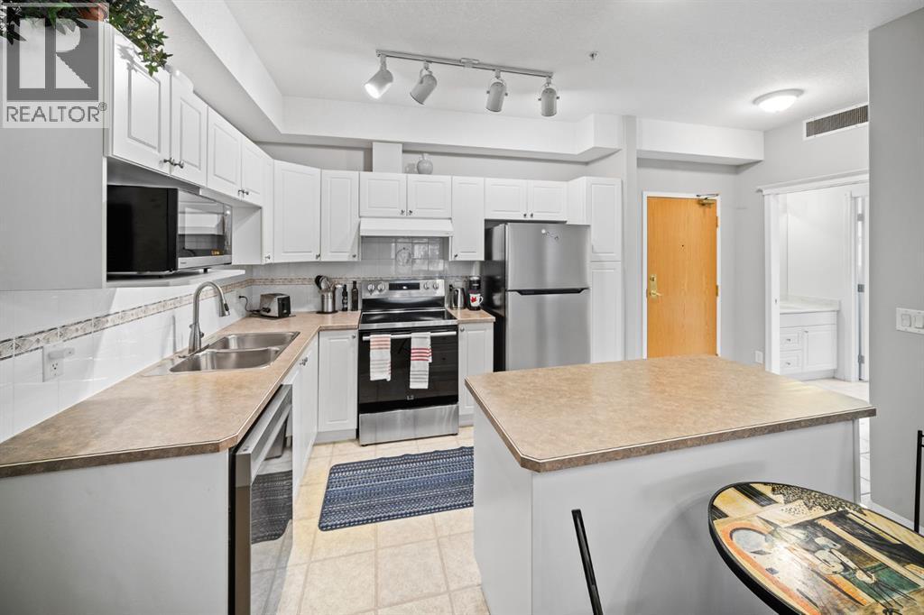 201, 223 Tuscany Springs Boulevard Nw, Calgary, AB - Indoor Photo Showing Kitchen With Stainless Steel Kitchen With Double Sink