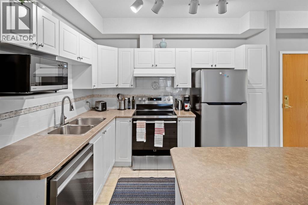 201, 223 Tuscany Springs Boulevard Nw, Calgary, AB - Indoor Photo Showing Kitchen With Stainless Steel Kitchen With Double Sink