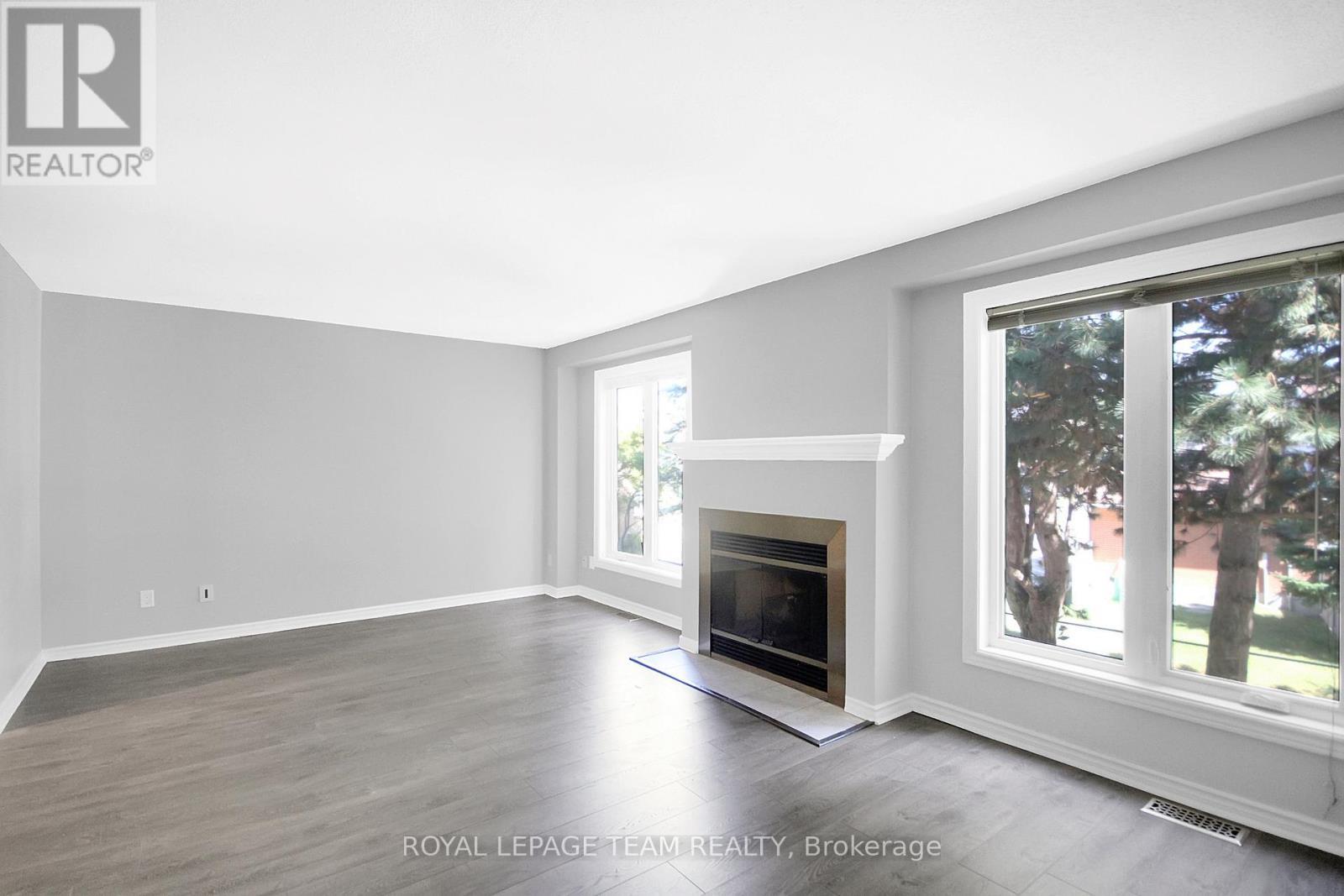 4 - 7 Wrenwood Crescent, Ottawa, ON - Indoor Photo Showing Living Room With Fireplace