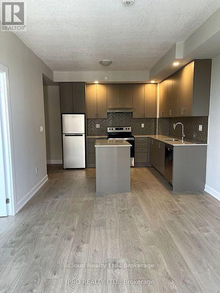1706 - 3220 William Coltson Ave. Avenue, Oakville, ON - Indoor Photo Showing Kitchen With Stainless Steel Kitchen