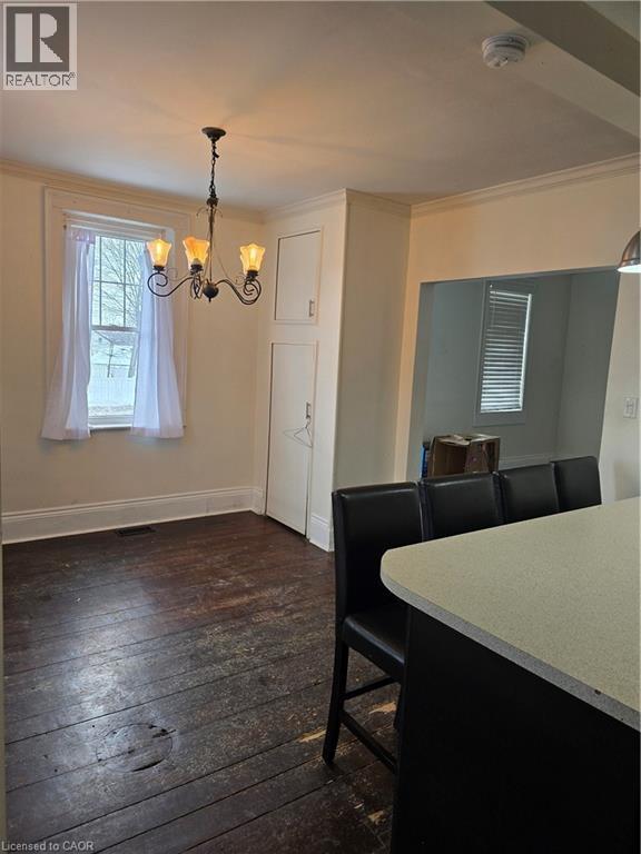 Dining area featuring dark wood-style flooring, crown molding, and a chandelier - 10 Centre Street, Elmira, ON - Indoor Photo Showing Other Room